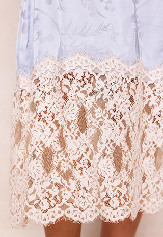 close-up-of-a-light-blue-skirt-with-a-wide-cream-lace-overlay-hem-showing-the-floral-lace-pattern-and-sheer-mesh-underneath
